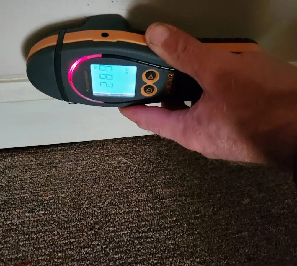 Moisture detection at baseboard during Sewage Cleanup & Sanitation in Bend